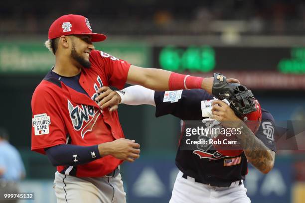 Fernando Tatis of the San Diego Padres and the World Team and Buddy Reed of the San Diego Padres and the U.S. Team play around after the eighth...