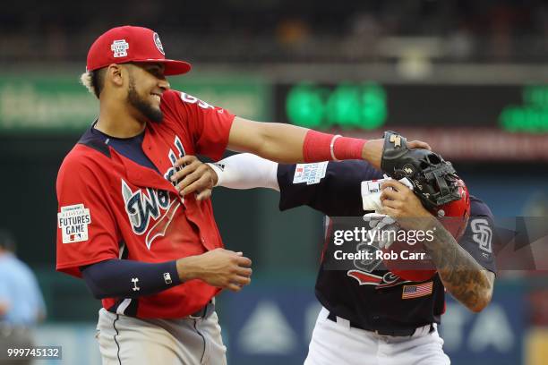 Fernando Tatis of the San Diego Padres and the World Team and Buddy Reed of the San Diego Padres and the U.S. Team play around after the eighth...