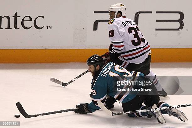Joe Thornton of the San Jose Sharks moves the puck alongside Dustin Byfuglien of the Chicago Blackhawks in the third period of Game Two of the...