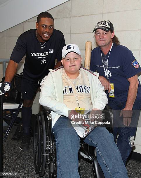 New York Yankees left fielder Marcus Thames, Jack Williams, and Roger Williams pose for pictures at the starter event at NY Yankees batting practice...