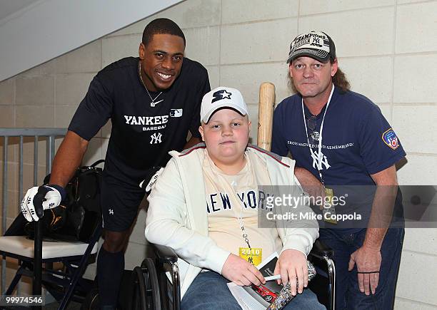 New York Yankees left fielder Marcus Thames, Jack Williams, and Roger Williams pose for pictures at the starter event at NY Yankees batting practice...