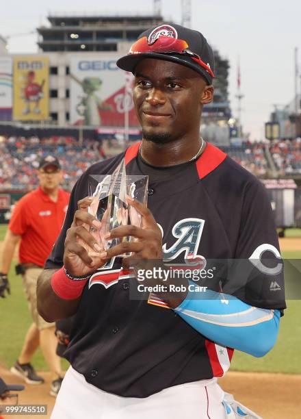 Taylor Trammell of the Cincinnati Reds and the U.S. Team poses with the Larry Doby Award after defeating the World Team in the SiriusXM All-Star...