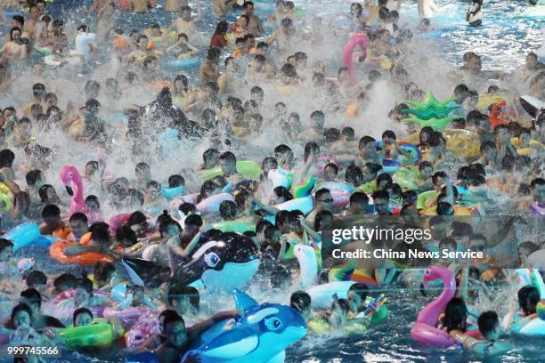 Citizens enjoy cool moments at a water park on July 13, 2018 in Nanjing, Jiangsu Province of China. According to the Central Meteorological...