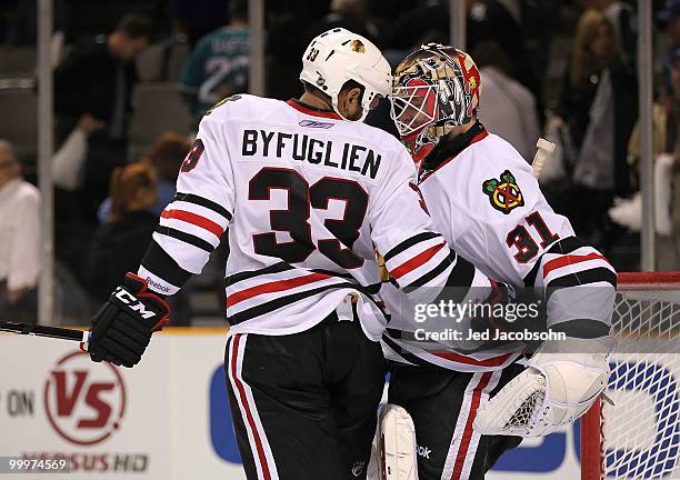 Dustin Byfuglien and goaltender Antti Niemi of the Chicago Blackhawks celebrate the Blackhawks 4-2 victory against the San Jose Sharks in Game Two of...