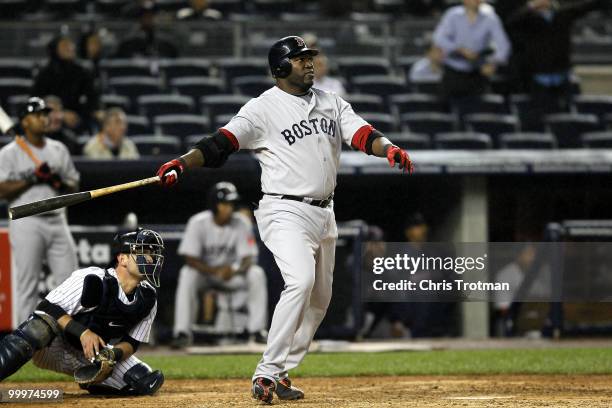 David Ortiz of the Boston Red Sox hits an RBI single in the eighth inning against the New York Yankees on May 18, 2010 at Yankee Stadium in the Bronx...