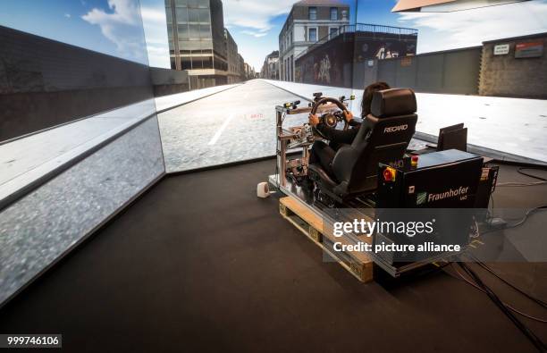 Young woman sits in a driving simulator in the Fraunhofer Institute for Industrial Engineering in Stuttgart, Germany, 4 September 2017. Photo:...