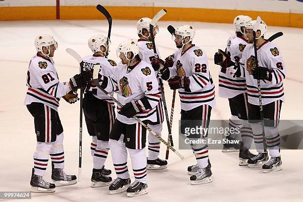 Brent Sopel and Troy Brouwer of the Chicago Blackhawks celebrate the Blackhawks 4-2 victory with teammates after defeating the San Jose Sharks in...