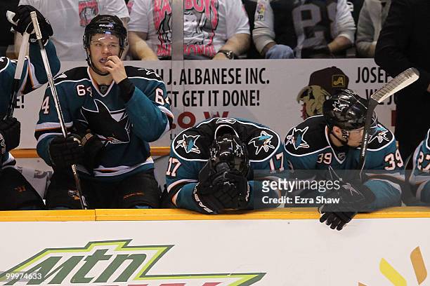 Jamie McGinn, Torrey Mitchell and Logan Couture of the San Jose Sharks on the bench late in the fourth period before losing to the Chicago Blackhawks...
