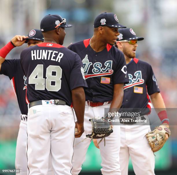 Manager Torii Hunter of Team USA visits Hunter Greene on the mound during the SiriusXM All-Star Futures Game at Nationals Park on Sunday, July 15,...