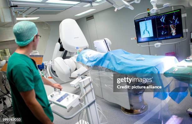 Technical assistant operates a newly installed hybrid surgery robot during a radiological examination in the Red Cross Hospital in Bremen, Germany, 7...