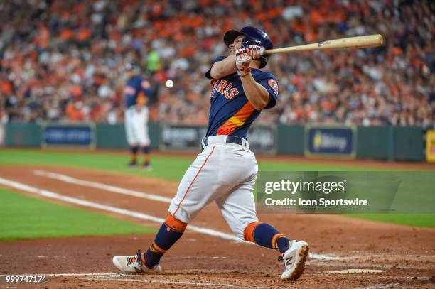 Houston Astros infielder Jose Altuve watches a hit on his follow through during the baseball game between the Detroit Tigers and the Houston Astros...