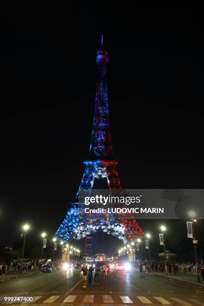 The Eiffel Tower illuminated in French national colors is seen during celebrations after the Russia 2018 World Cup final football match between...