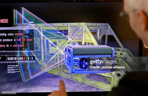 Jan Albiez von der Firma Kraken Robotik GmbH presents a laser system for the scanning of underwater objects at an exhibition on the trade fair...