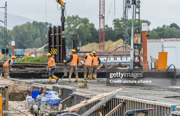 Concrete reinforcement slab is poured by workers in the construction site where a railway tunnel partially collapsed several days ago in Rastatt,...