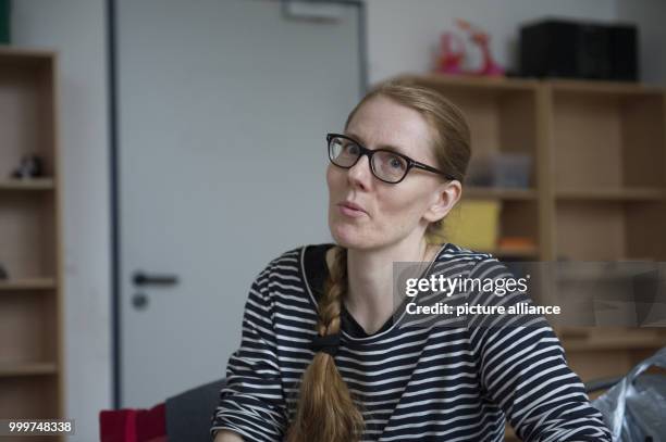 Kati Hyyppaei from Finland sits in the room of a refugee home in Berlin, Germany, 6 September 2017. Hyyppaei voluntarily offers sewing courses for...