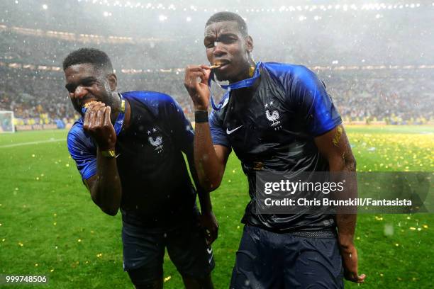 Paul Pogba and Samuel Umtiti celebrate with their medals following the 2018 FIFA World Cup Russia Final between France and Croatia at Luzhniki...