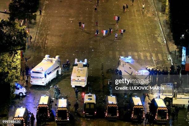 This picture taken from the top of the Arch of Triumph on July 15, 2018 shows security forces working to contain clashes following celebrations of...