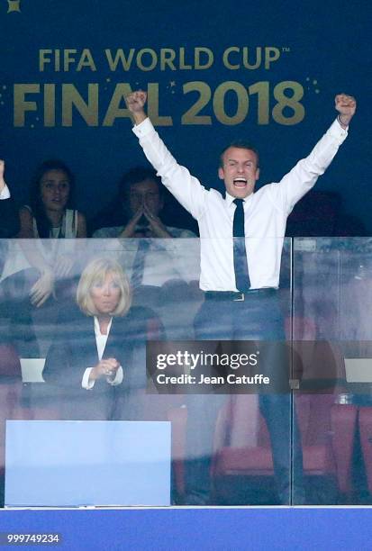 President of France Emmanuel Macron celebrates the victory while his wife Brigitte Macron stays seated during the 2018 FIFA World Cup Russia Final...