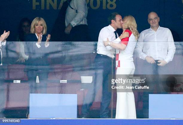 President of France Emmanuel Macron greets President of Croatia Kolinda Grabar-Kitarovic after the victory while his wife Brigitte Macron looks on...