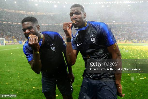 Paul Pogba and Samuel Umtiti of France celebrate with their medals following the 2018 FIFA World Cup Russia Final between France and Croatia at...