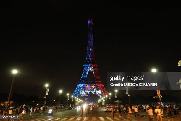 The Eiffel Tower is illuminated Blue, White and Red, colors of the french flag, as a tribute to the french football team who won the world cup for...