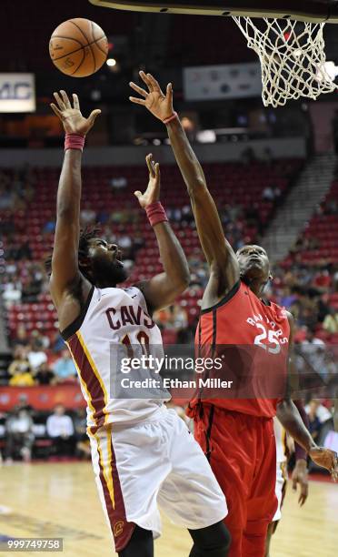 John Holland of the Cleveland Cavaliers shoots against Chris Boucher of the Toronto Raptors during a quarterfinal game of the 2018 NBA Summer League...