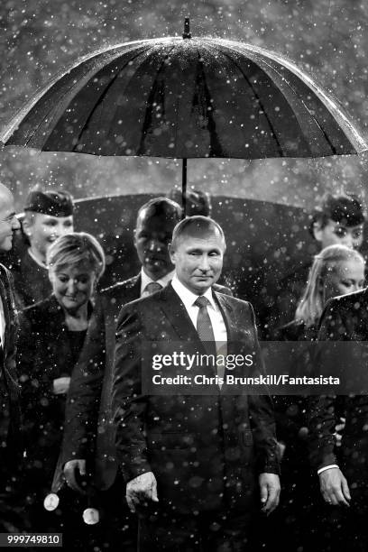 President of Russia Vladimir Putin shelters from the rain after the 2018 FIFA World Cup Russia Final between France and Croatia at Luzhniki Stadium...