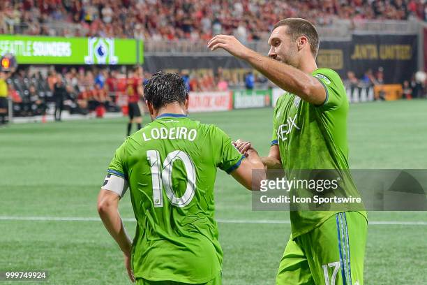 Seattle's Nicolás Lodeiro is congratulated by teammate Will Bruin after scoring on a penalty kick during the match between Atlanta and Seattle on...