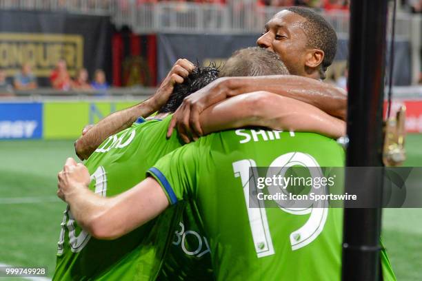 Seattle's Nicolás Lodeiro is mobbed by teammates after scoring on a penalty kick to score Seattle's only goal during the match between Atlanta and...