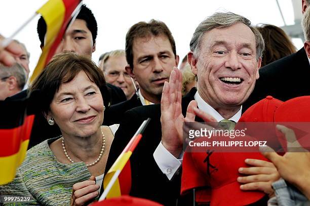 German President Horst Koehler and his wife Eva Luise are greeted by children waving German flags at the site of the World Expo 2010 in Shanghai on...