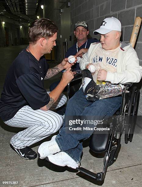 New York Yankees pitcher A. J. Burnett, Roger Williams, and Jack Williams attend the starter event at NY Yankees batting practice at Yankee Stadium...