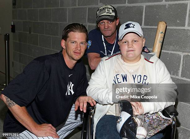 New York Yankees pitcher A. J. Burnett, Roger Williams, and Jack Williams attend the starter event at NY Yankees batting practice at Yankee Stadium...