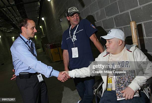 New York Yankees General Manager Brian Cashman, Jack Williams, and Roger Williams attend the starter event at NY Yankees batting practice at Yankee...