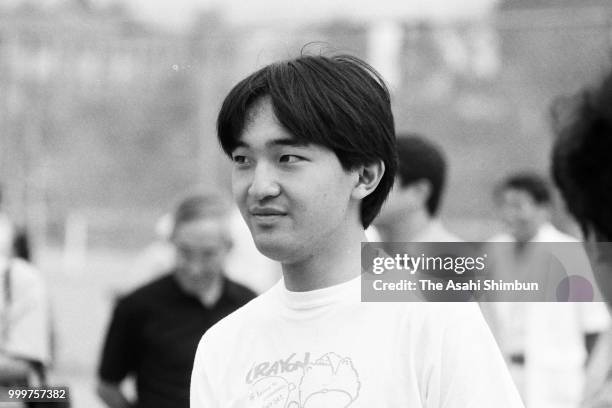 Prince Fumihito talks with friends while playing tennis on August 7, 1986 in Karuizawa, Nagano, Japan.