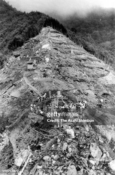 In this aerial image, bereaved family members climbs the Mt. Osutaka to commemorate the victims of the JAL 123 crash on August 12, 1986 in Ueno,...
