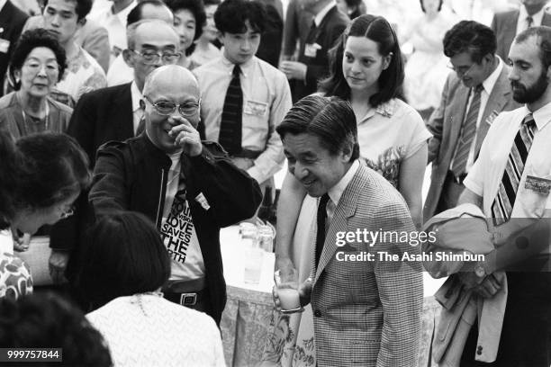 Crown Prince Akihito talks with guests during the Karuizawa International Friendship Meeting party on August 10, 1986 in Karuizawa, Nagano, Japan.