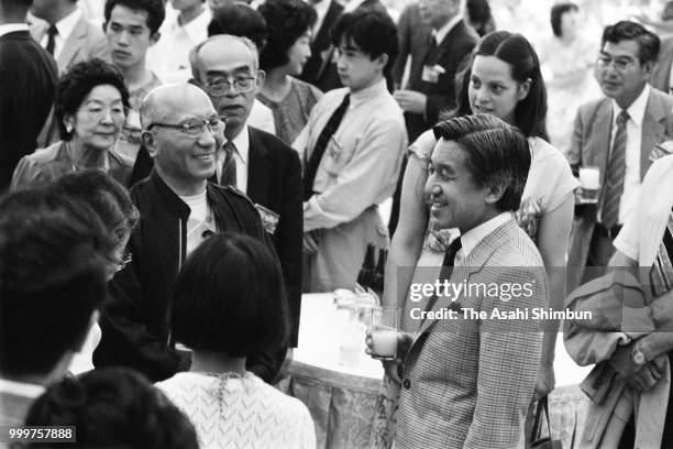 Crown Prince Akihito talks with guests during the Karuizawa International Friendship Meeting party on August 10, 1986 in Karuizawa, Nagano, Japan.