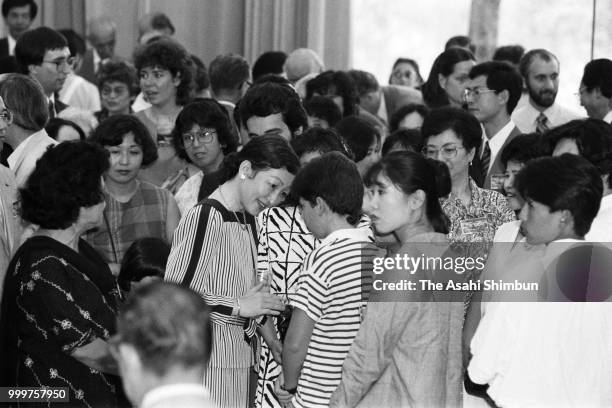 Crown Princess Michiko talks with guests during the Karuizawa International Friendship Meeting party on August 10, 1986 in Karuizawa, Nagano, Japan.