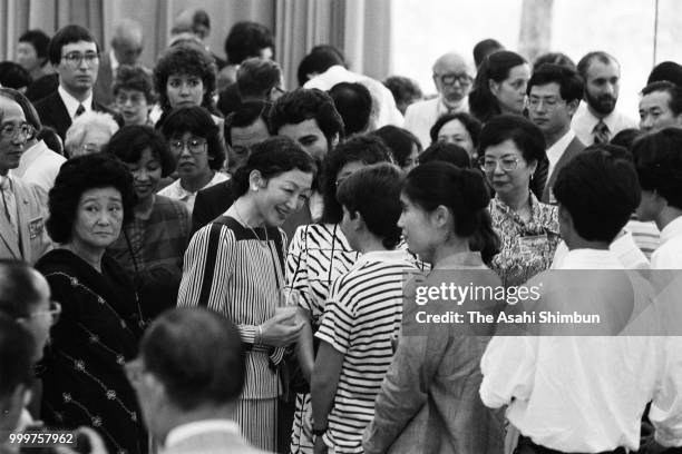 Crown Princess Michiko talks with guests during the Karuizawa International Friendship Meeting party on August 10, 1986 in Karuizawa, Nagano, Japan.