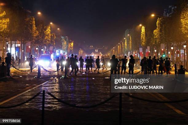 Security forces guard the unknown soldier grave and flame, under the arc de triomphe near the Champs Elysee avenue, during clashes following...