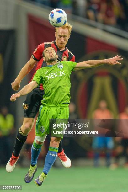 Atlanta's Jeff Larentowicz and Seattle's Víctor Rodríguez battle for a header during the match between Atlanta and Seattle on July 15th, 2018 at...