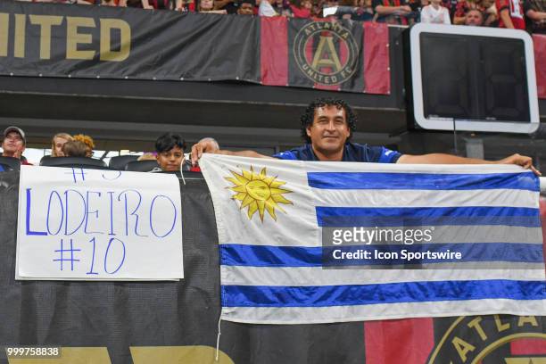 Fan of Seattles Nicolás Lodeiro poses with a Uruguay flag during the match between Atlanta and Seattle on July 15th, 2018 at Mercedes-Benz Stadium in...