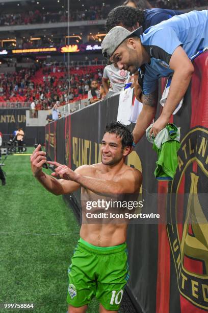 Seattles Nicolás Lodeiro takes a selfie with fans after the match concluded between Atlanta and Seattle on July 15th, 2018 at Mercedes-Benz Stadium...