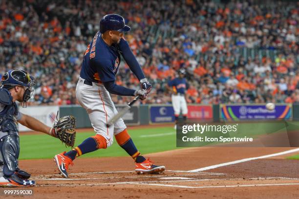 Houston Astros outfielder George Springer prepares to hit a hard shot to the shortstop during the baseball game between the Detroit Tigers and the...