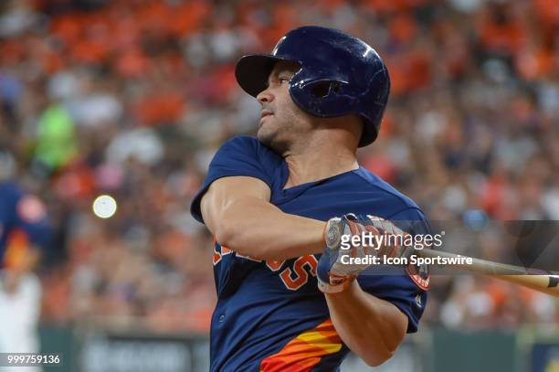 Houston Astros infielder Jose Altuve watches a hit on his follow through during the baseball game between the Detroit Tigers and the Houston Astros...
