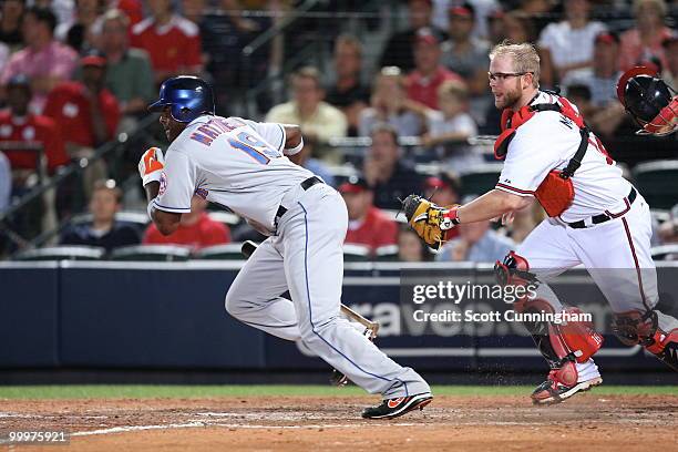 Brian McCann of the Atlanta Braves looks to field a bunt by Gary Matthews of the New York Mets at Turner Field on May 18, 2010 in Atlanta, Georgia....
