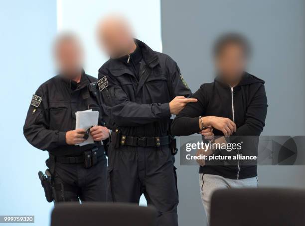 The defendant Nasser A. Is brought into the court room by judicial officers at the district court in Dresden, Germany, 8 September 2017. The 25 year...