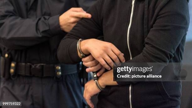 The defendant Nasser A. Is brought into the court room at the district court in Dresden, Germany, 8 September 2017. The 25 year old Syrian man is...
