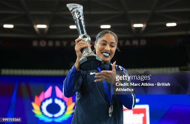 Captain Queen Harrison poses with the trophy as Team USA celebrate victory during Day Two of the Athletics World Cup 2018 presented by Muller at...