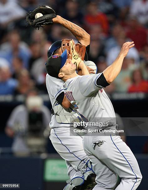 Henry Blanco of the New York Mets makes a catch as he collides with David Wright during the game against the Atlanta Braves at Turner Field on May...